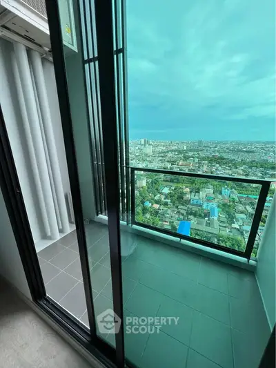 Stunning high-rise balcony with panoramic city view, perfect for urban living.