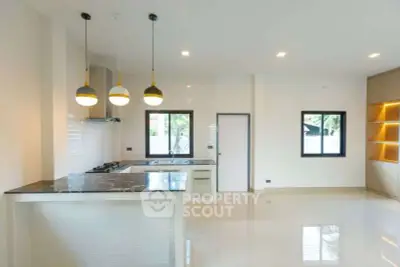 Modern kitchen with open layout and stylish lighting fixtures