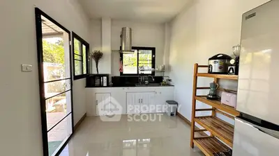 Modern kitchen with sleek black countertops and ample natural light.