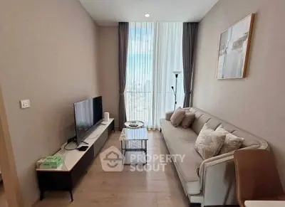 Modern living room with stylish decor and city view through large window.