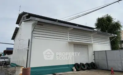 Industrial warehouse exterior with large roller door and ample outdoor space.