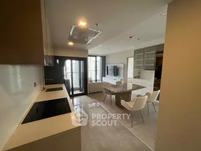 Modern open-layout kitchen and dining area with sleek design and natural light.