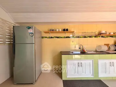 Modern kitchen with stainless steel fridge and stylish cabinetry