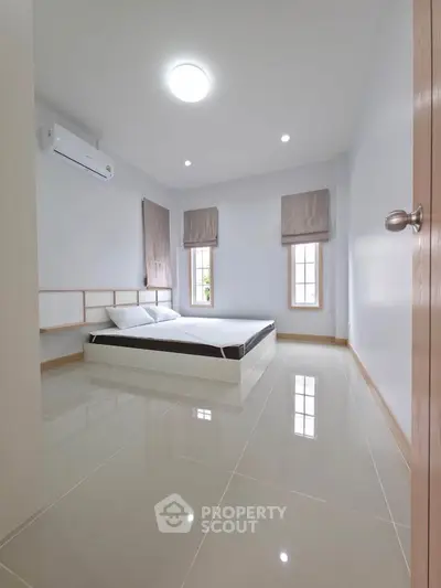 Spacious minimalist bedroom with modern design and natural light