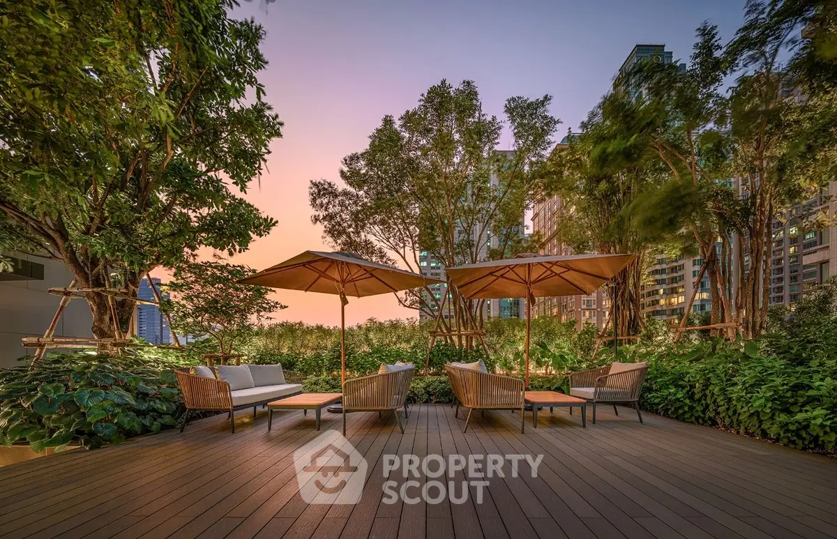 Luxurious rooftop garden with elegant seating and sunset view in urban setting.