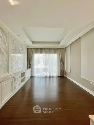 Spacious living room with elegant marble accents and large windows for natural light.