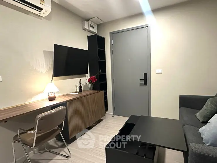 Modern living room with sleek furniture and wall-mounted TV, perfect for cozy relaxation.