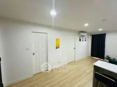 Modern minimalist interior with wooden flooring and bright lighting