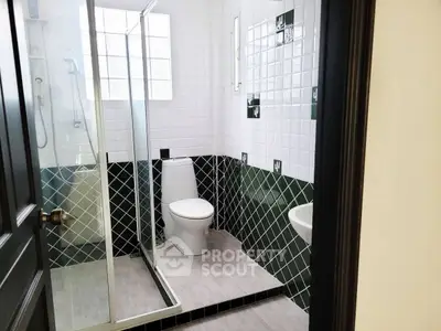 Modern bathroom with glass shower and stylish tile design