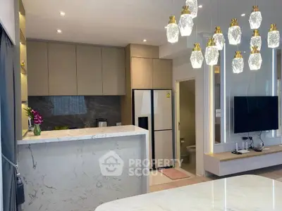 Modern kitchen with marble countertops and elegant lighting in a stylish apartment.