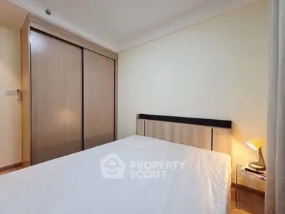 Cozy bedroom with wooden wardrobe and modern lighting