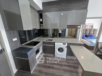 Modern kitchen with sleek cabinetry and built-in appliances in a stylish apartment