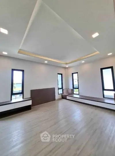 Spacious modern living room with large windows and sleek design