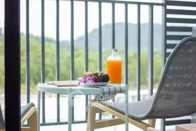 Charming balcony with scenic view and cozy seating, perfect for relaxation.