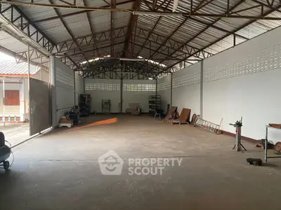 Spacious industrial warehouse with high ceilings and ample storage space.