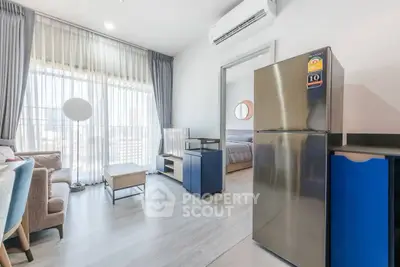 Modern apartment living room with stylish furniture and large window for natural light.