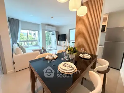 Modern open-plan living and dining area with elegant decor and natural light.