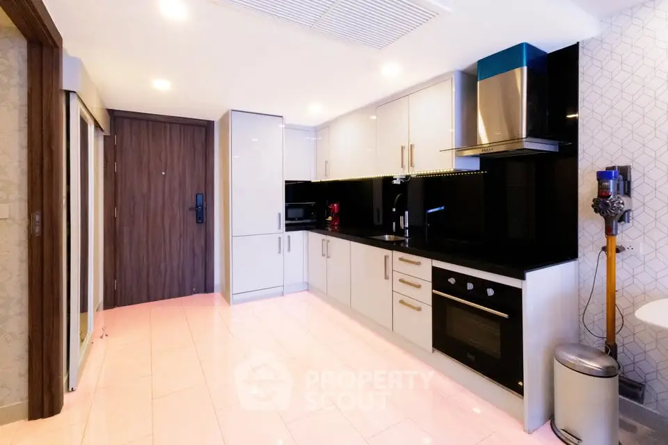 Modern kitchen with sleek cabinetry and built-in appliances in a stylish apartment.