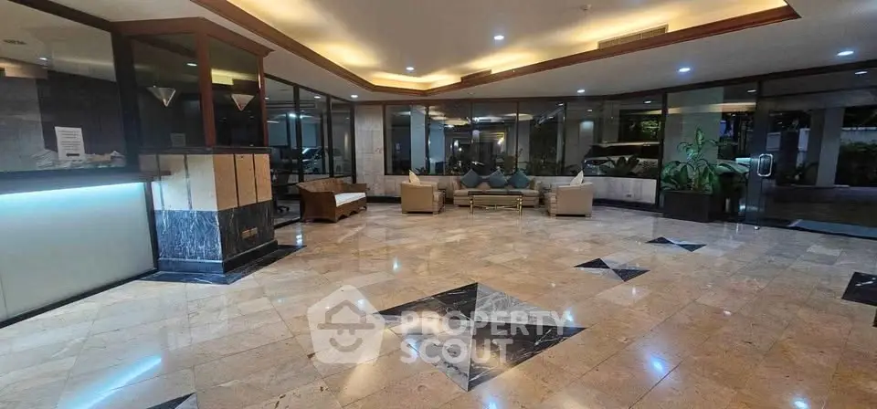 Luxurious building lobby with elegant marble flooring and modern seating area.
