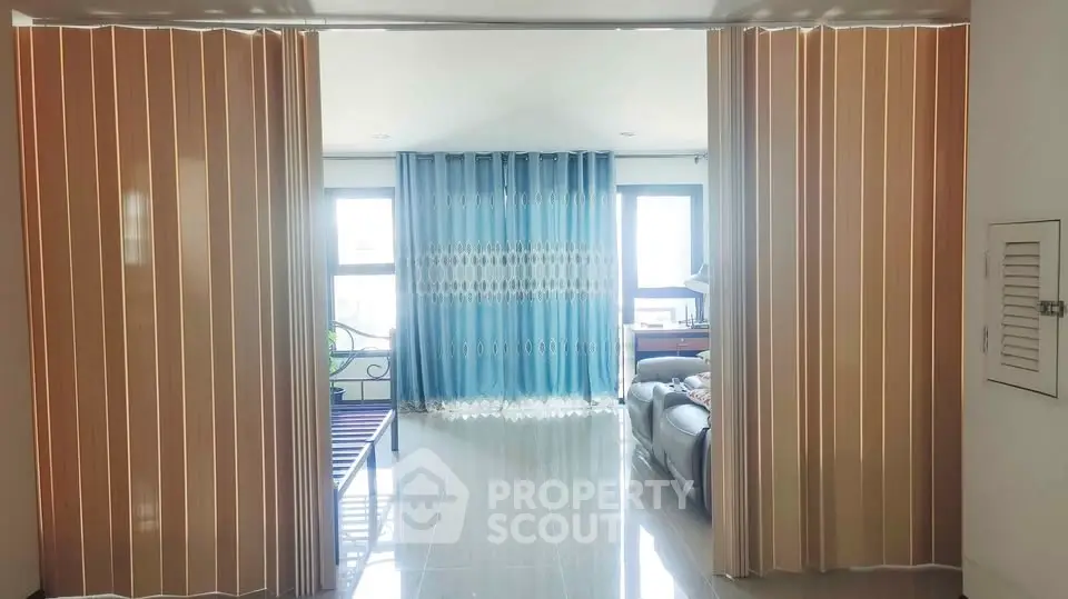 Spacious living area with sliding partitions and large windows for natural light.