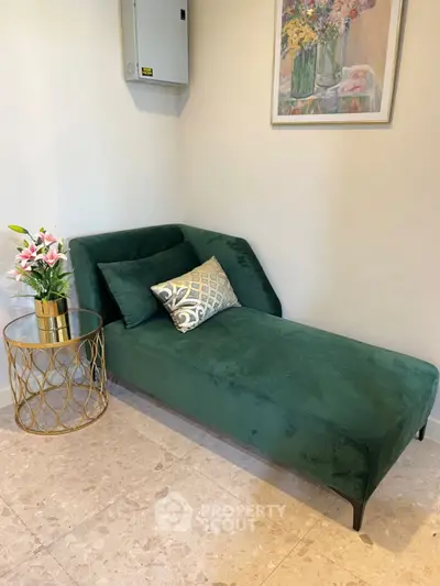 Stylish interior with green chaise lounge and elegant side table in cozy corner.