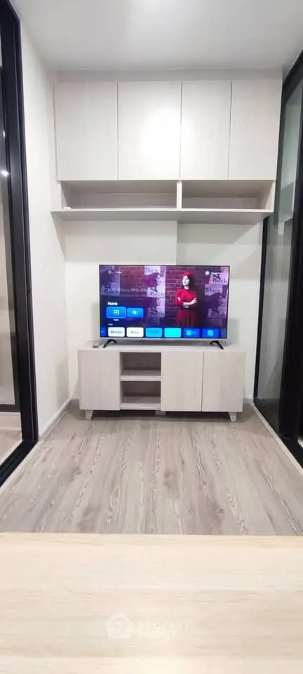 Modern living room with sleek TV setup and stylish cabinetry