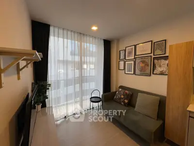 Cozy living room with modern decor and large window for natural light