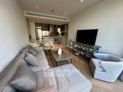 Modern living room with stylish furniture and open kitchen layout