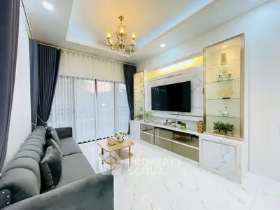 Luxurious living room with elegant chandelier and modern entertainment center