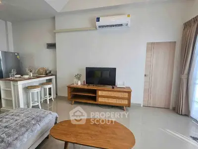 Modern living room with stylish furniture and open kitchen layout