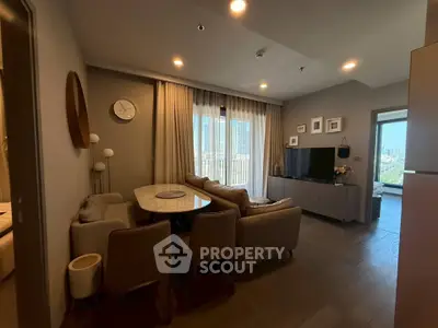 Modern living room with city view, stylish furniture, and elegant decor in a high-rise apartment.
