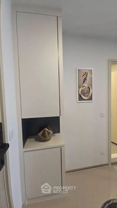 Modern minimalist interior with sleek cabinetry and stylish decor accents.