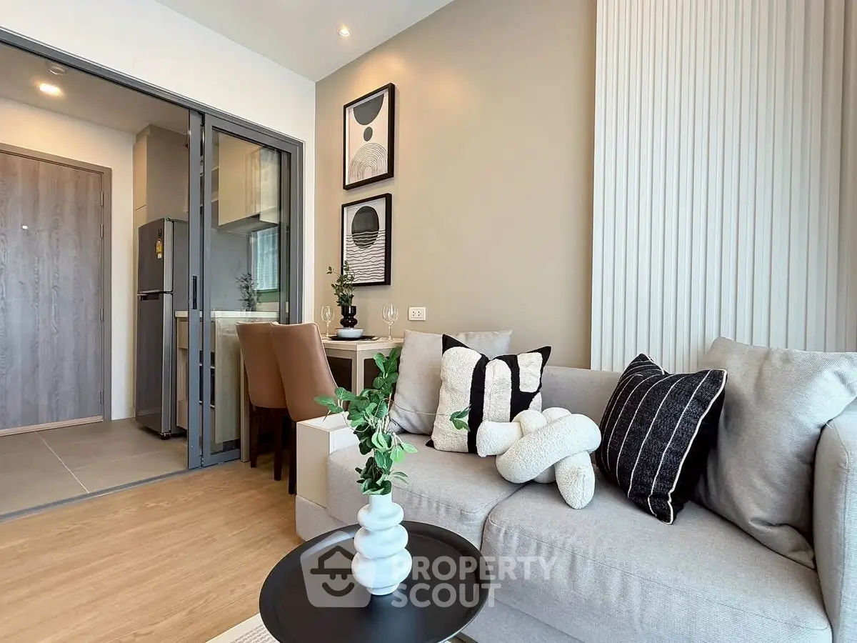 Modern living room with stylish decor and open kitchen layout, perfect for urban living.