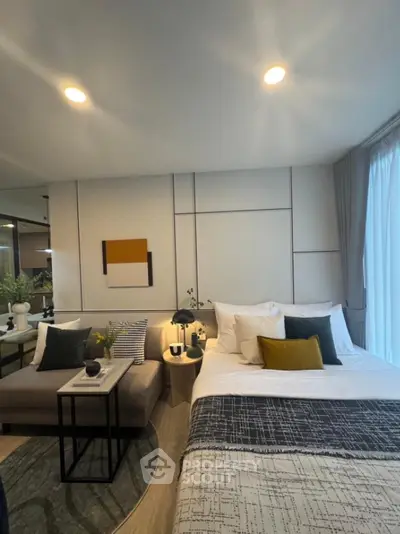 Modern bedroom with stylish decor and cozy seating area
