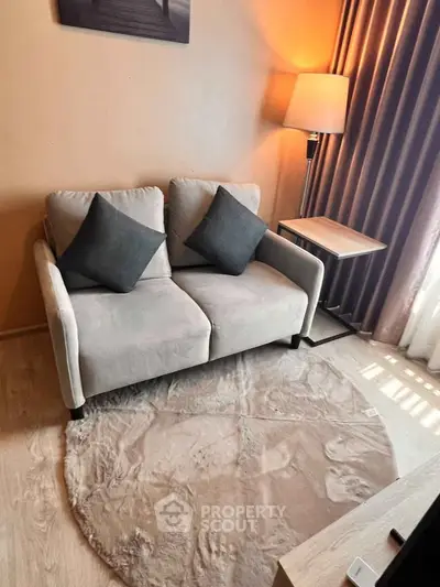 Cozy living room with stylish sofa and elegant lighting, perfect for relaxation.