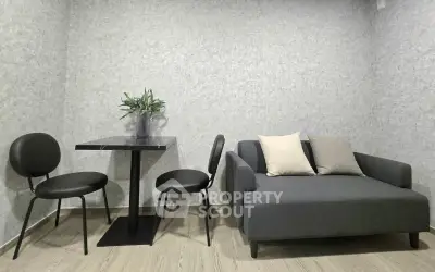 Modern living room with sleek gray sofa and stylish dining set
