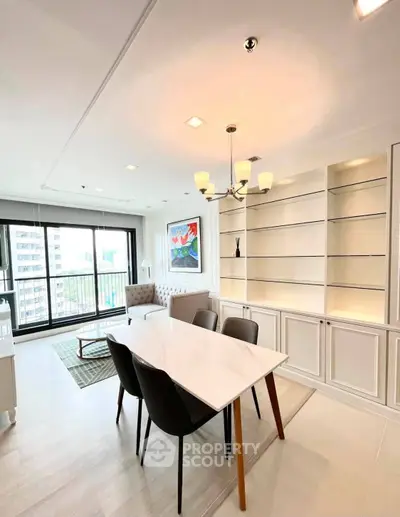 Modern dining area with elegant chandelier and large windows offering city views