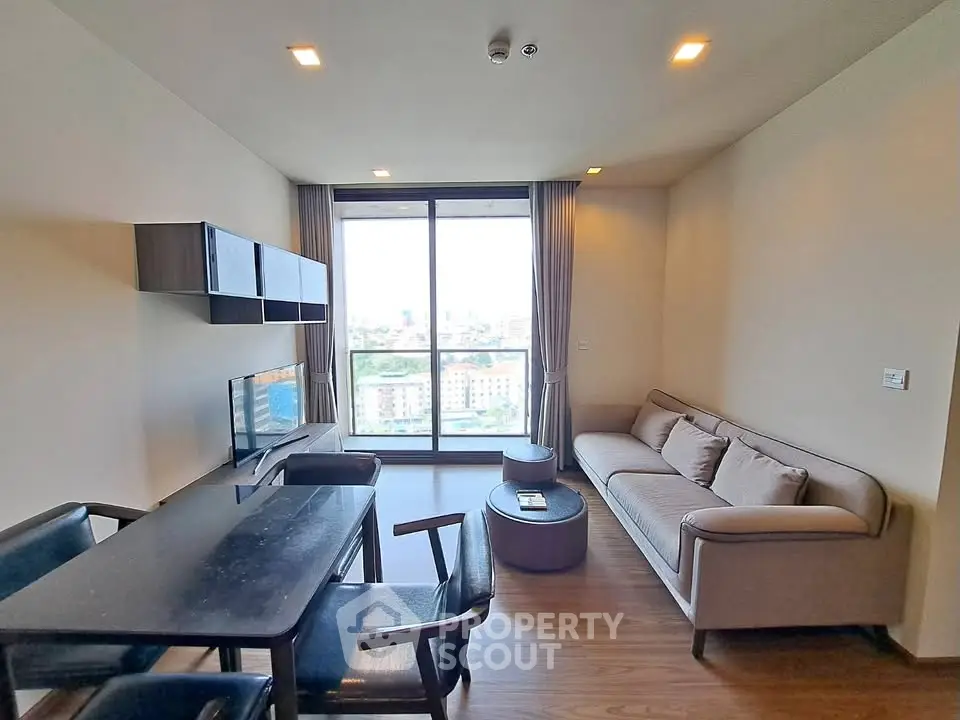 Modern living room with city view, sleek furniture, and natural light.