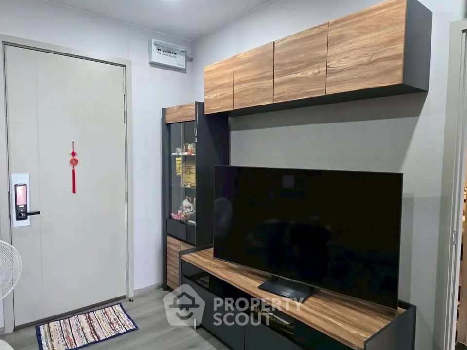Modern living room with sleek TV unit and wooden cabinets, perfect for cozy entertainment.