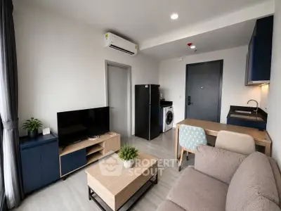 Modern living room with sleek furniture and integrated kitchen appliances in a stylish apartment.