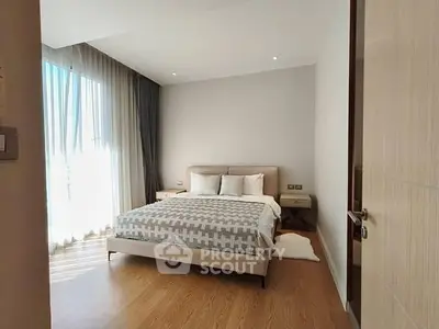 Spacious modern bedroom with natural light and elegant decor