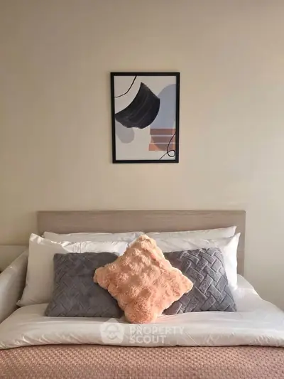 Cozy bedroom with stylish decor and plush pillows, perfect for relaxation and comfort.