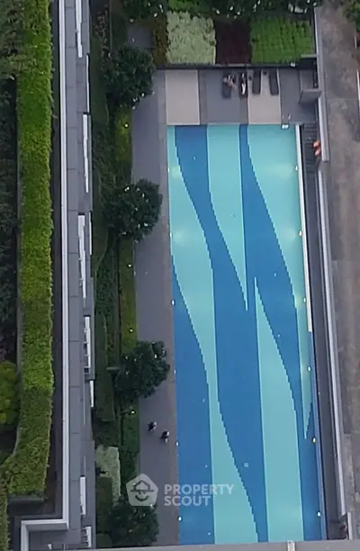 Luxurious rooftop pool with stunning design and lush greenery in modern residential complex.