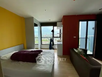 Modern bedroom with large windows and city view, featuring cozy bed and stylish decor.