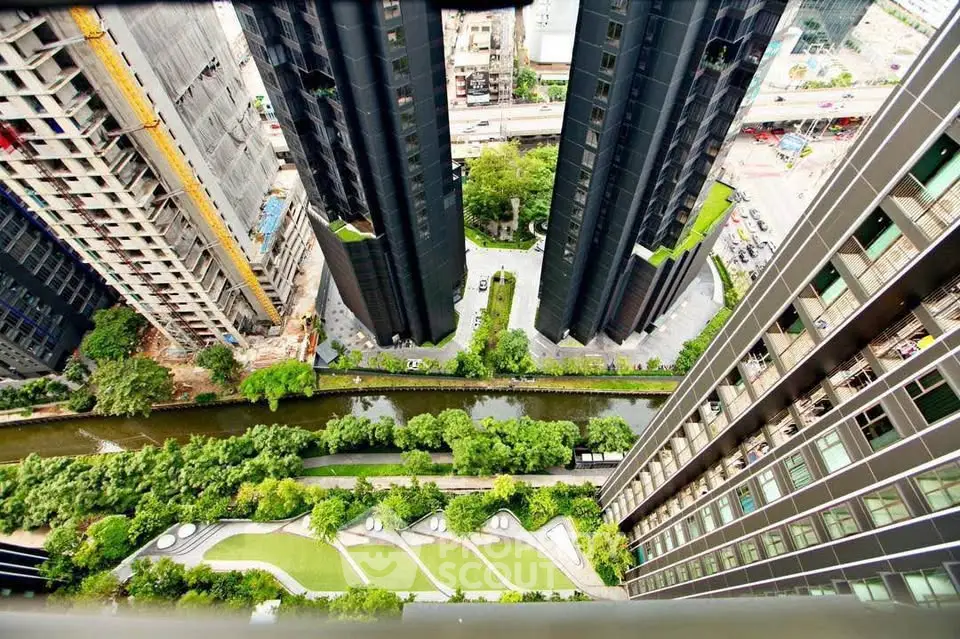 Stunning aerial view of modern high-rise buildings with lush green landscaping and urban surroundings.
