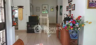 Charming living room with elegant decor and vibrant floral arrangement