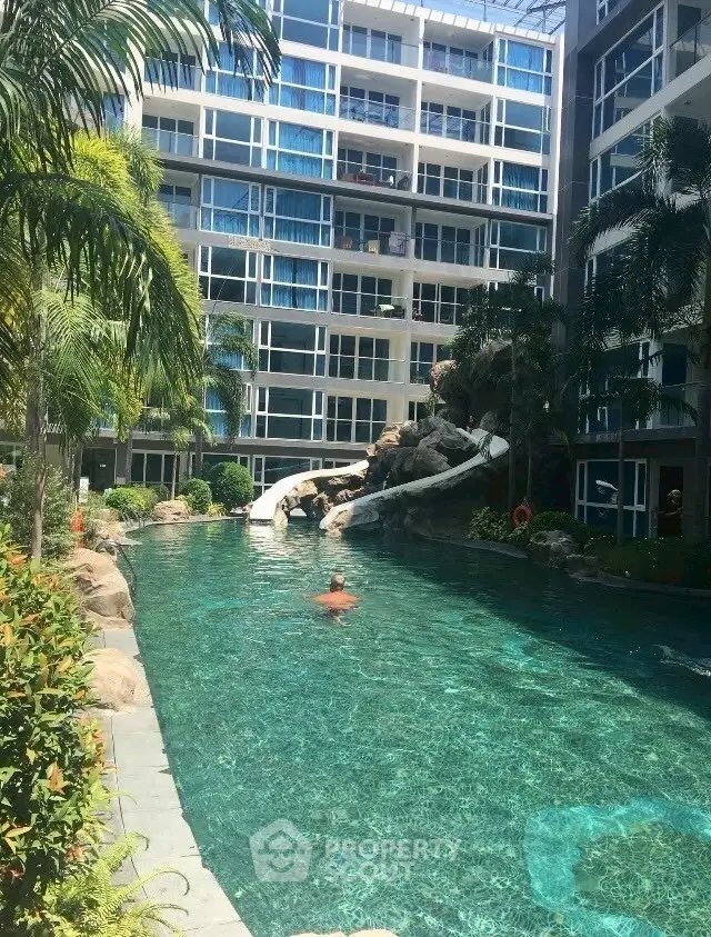 Luxurious condominium with stunning pool and lush greenery, perfect for resort-style living.