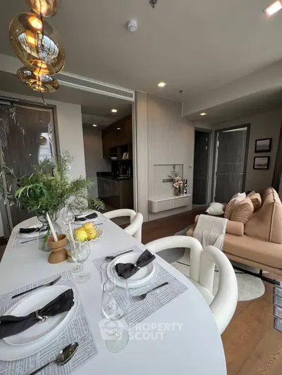 Modern living room with elegant dining setup and cozy seating area.