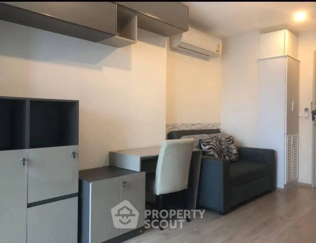 Modern living room with sleek furniture and air conditioning in a cozy apartment.