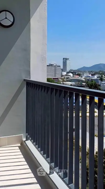 Modern balcony with city view and mountain backdrop, perfect for relaxation and enjoying the skyline.